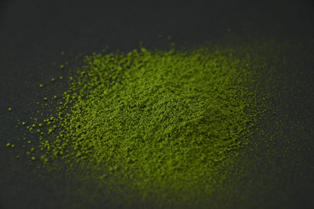 SR-5 matcha powder heaped on a dark surface