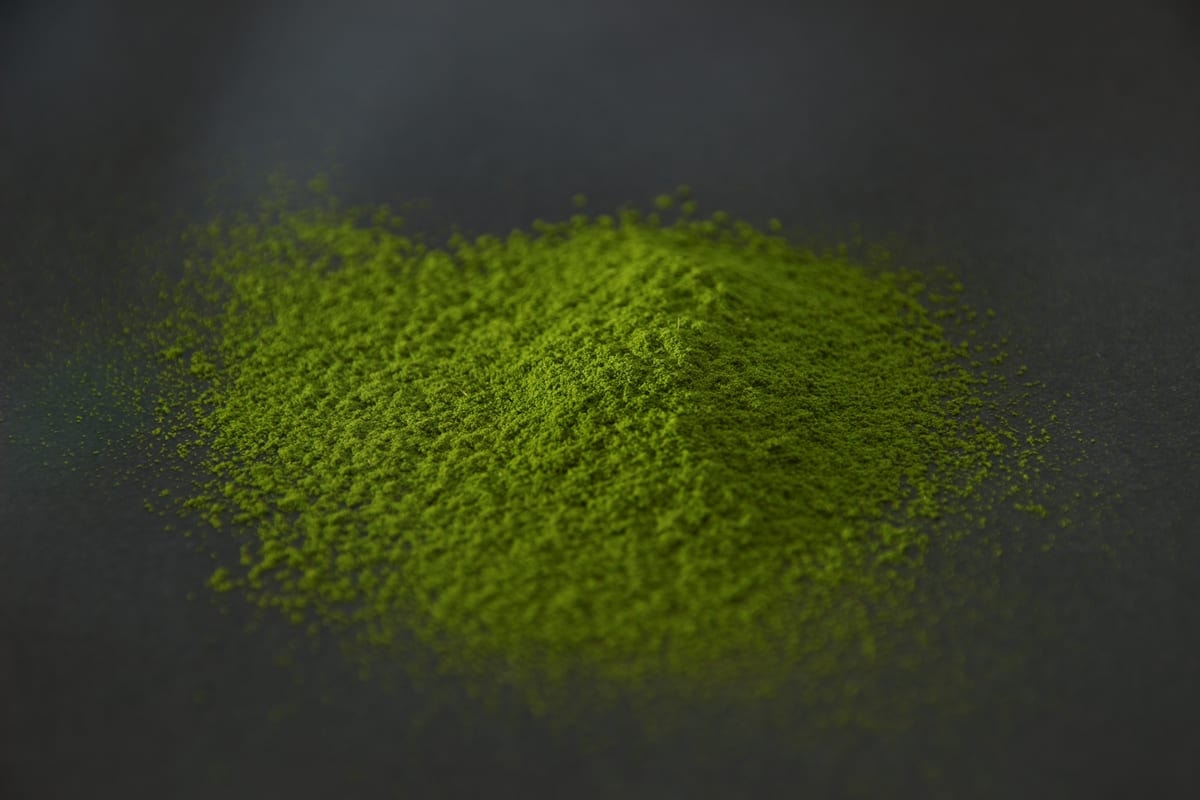 YAME 1 matcha powder heaped on a dark surface