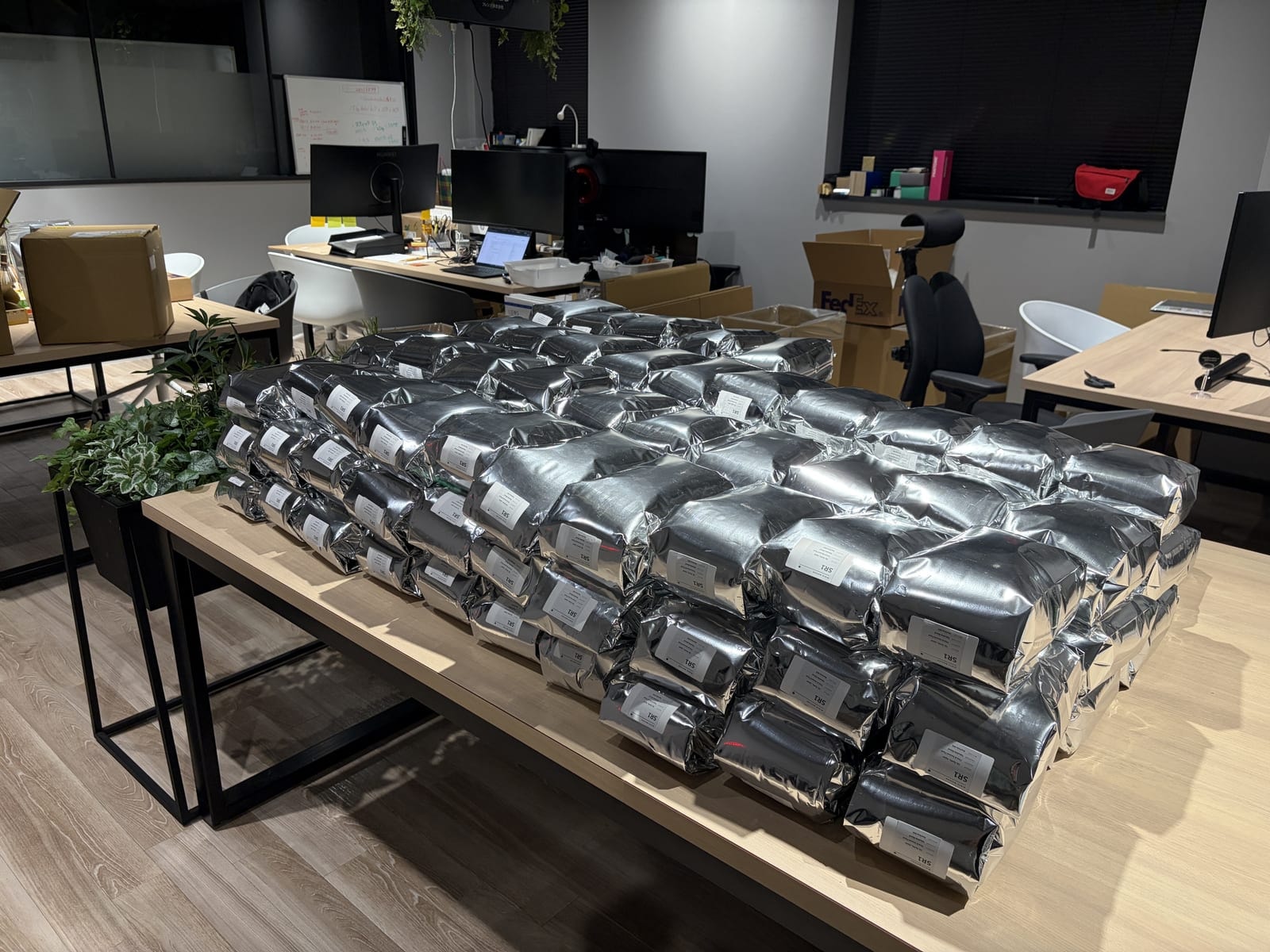 Silver bags of matcha stacked on a table in the RIKYU Tokyo office