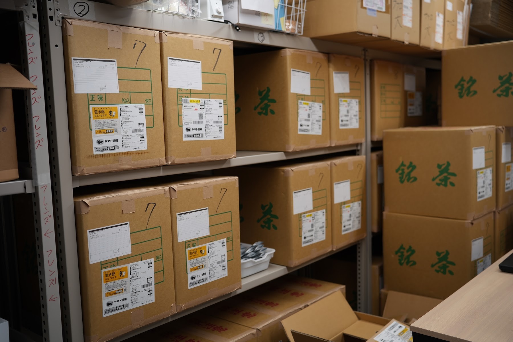 Boxes of matcha stacked on shelves in the RIKYU stockroom