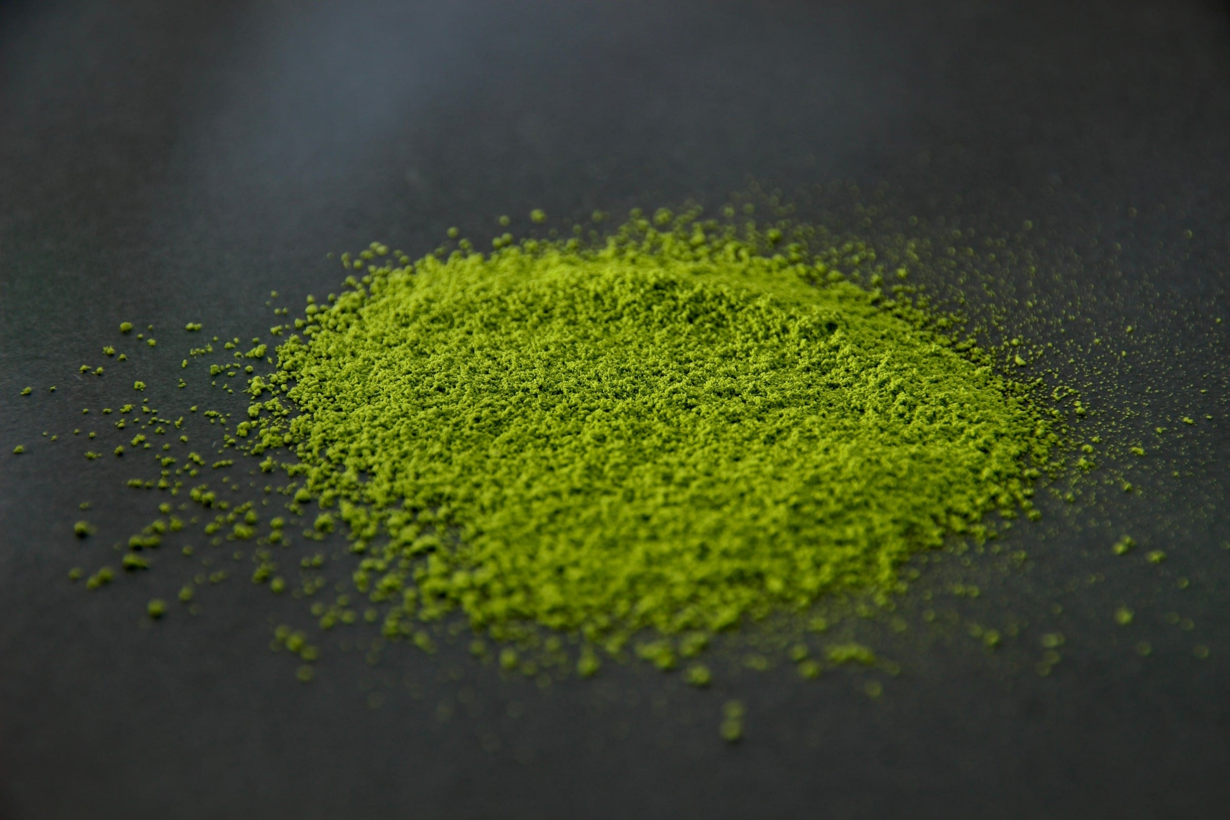 YAME 2 matcha powder heaped on a dark surface