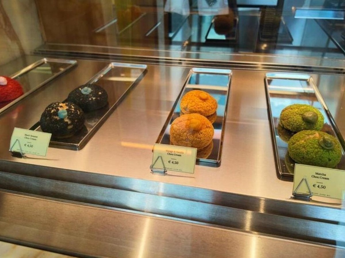 Pastry case at Café Onitsuka Tiger, Milan, with matcha chou cream at €4.50 alongside black sesame and mango chou creams