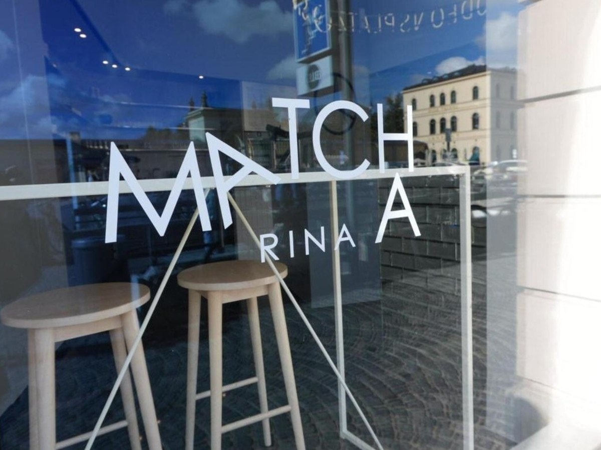 Matcha Rina café window near Odeonsplatz in Munich, with the shop name lettered on the glass and bar stools inside